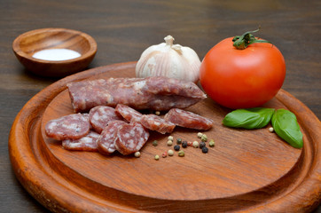 sausage with pepper and garlic and tomatoes on the board