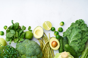 Creative flat lay with healthy vegetarian meal ingredients. Raw food concept. A variety of organic fruits and vegetables with avocado. Vegan menu.