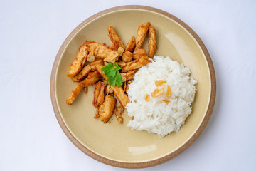Fried meat chicken with black pepper and Garlic sauce oserved with Thai jasmine rice on the plate. isolated on white background.In Thai it call 