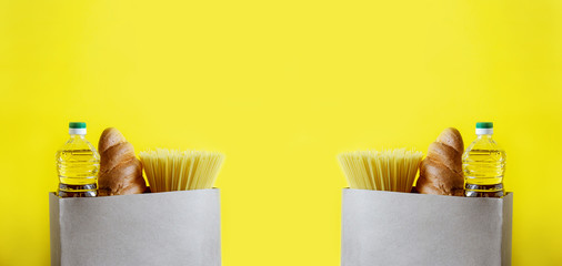 Macaroni, sunflower oil and bread in a paper bag on a yellow isolated background, repeated several...