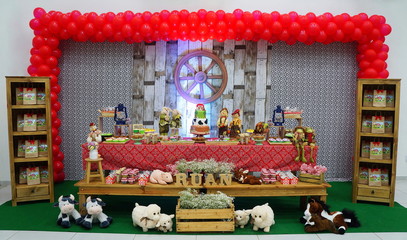 Child's birthday. Farm theme. Cake table with sweets and decoration