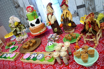 Child's birthday. Farm theme. Cake table with sweets and decoration