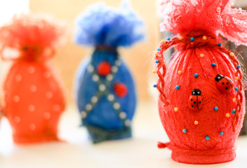 Colorful Easter eggs in colored lace on a light background