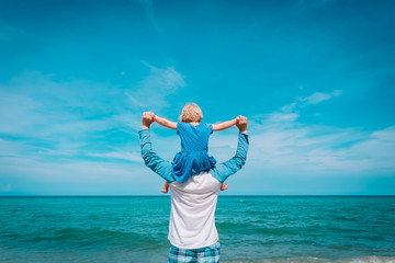 happy father and little daughter play on beach