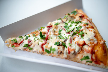 slice of delicious pizza delivered home