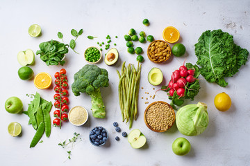 Creative flat lay with healthy vegetarian meal ingredients. Raw food concept. A variety of organic...