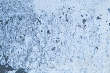Fototapeta na wymiar Rough cement grey background with white salt on it. Non-uniform surface of a concrete wall. The concept of texture, Wallpaper, and abstraction