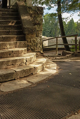 Fototapeta na wymiar round concrete steps at the exit to the river in the shade.