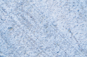 Rough cement background with the texture of a gray concrete wall. Non-uniform surface with oblique lines.