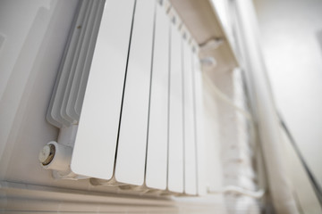 White heating radiator heat the room. Heating Radiator, White radiator in an apartment.