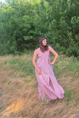 Fototapeta premium Pretty girl with long brunette hair in long dress and headband at the forest