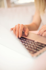 a young girl, female hands are printing on a laptop in a cafe , business woman, 