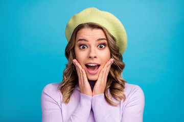 Portrait of astonished crazy girl look good see wonderful fall black friday promo impressed shout touch hands palms face wear paris style headwear sweater isolated over blue color background