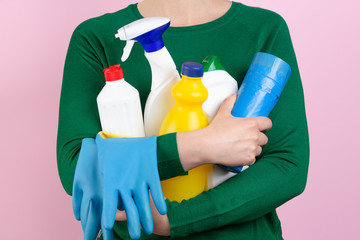 woman with many cleaning products in her arms