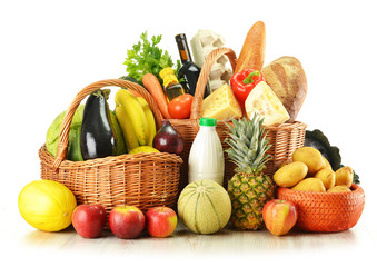 Groceries in wicker basket isolated on white