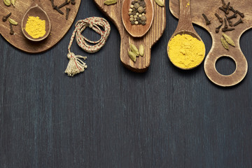 Colorful Spices and herbs over rustic wooden background. Photo with copy space.