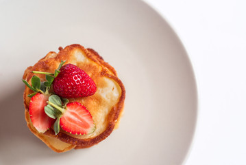 Russian traditional pancakes oladi with fresh strawberries. Top view.