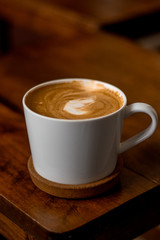 cup of coffee on wooden table