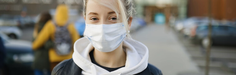 Banner of blonde girl in medical mask in street