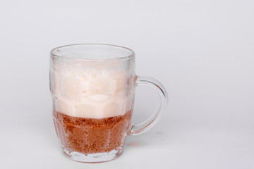 Mug of fresh light beer with foam isolated on a white background
