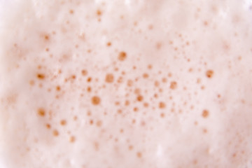 Beer foam from above as a background. Out of focus