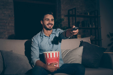 Portrait of his he nice attractive cheerful cheery brunet guy spending holiday sitting on divan...