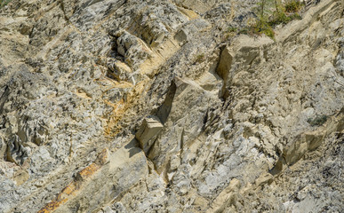 Striped natural texture of stones and rock fragments on Caucasus mountains on Black Sea coast in Olginka as original texture background. Brown, yellow, gray colored stone. Nature concept for design