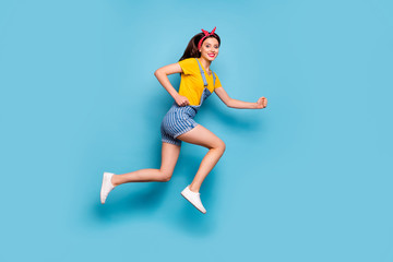 Fototapeta na wymiar Full length body size view of her she nice attractive lovely cheerful cheery energetic girl jumping running fast isolated over bright vivid shine vibrant blue color background