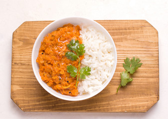 Dhal Indian vegetarian dish in a plate on a wooden board
