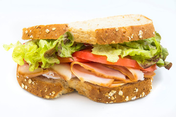 Sandwich of tomato, lettuce and smoked turkey