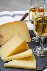 Spanish tapas, manchego cheese made, green olives served with glasses of dry fino sherry wine