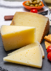 Spanish tapas, manchego cheese made, green olives served with glasses of dry fino sherry wine