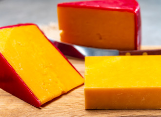 Red waxed yellow cheddar cheese close up