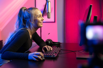 Professional esport gamer girl streaming vlog and plays online video game on PC © kjekol