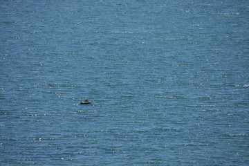 Fototapeta premium fisherman in a small boat on the high seas