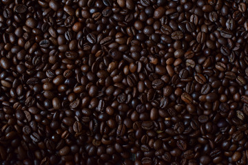 dark background of roasted coffee beans