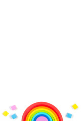 Baby kids toys background with wooden rainbow and colorful blocks. Top view, flat lay