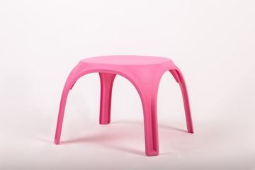 pink plastic childrens table on white background