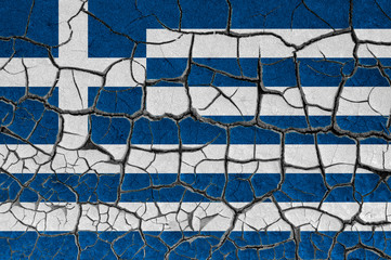 Flag of Greece on a cracked wall, dry ground