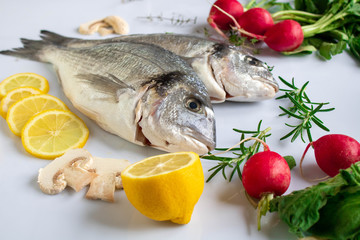 orata fresh fish ready to cook with vegetables and herbs as ingredient
