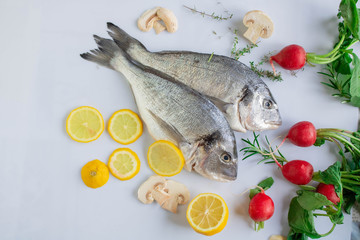 orata fresh fish ready to cook with vegetables and herbs as ingredient