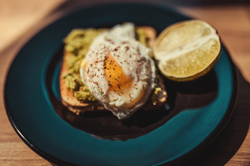 Poached egg with avocado cream on toast
