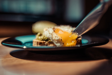 Poached egg with avocado cream on toast