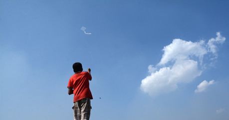 The boy is flying a kite with happiness