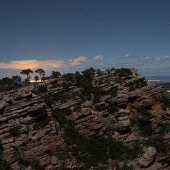 Beautiful cliff profile on a clear night with the city in the background