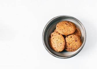 Oat biscuits Top view photo with copy space Homemade oatmeal cookies in a clay bowl on a white table