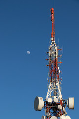 Telecommunication tower with moon in the background