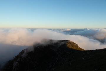 Beautiful clouds above the mountain with the sun in the background