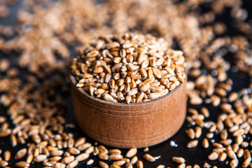 Whole grain wheat flour isolated. Wheat grain as background texture, top view.