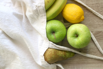 Various fruit in a canvas tote bag. Selective focus.